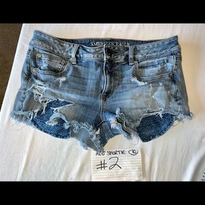 ***AEO 360 STRETCH SUPER DESTROYED MID RISE SHORTIE SIZE 10